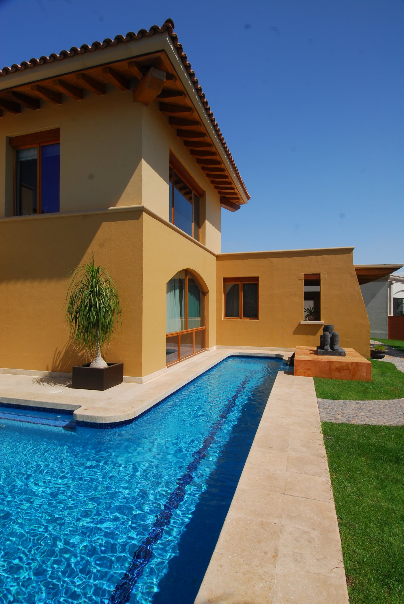 The long edge of the pool running the length of the garden face