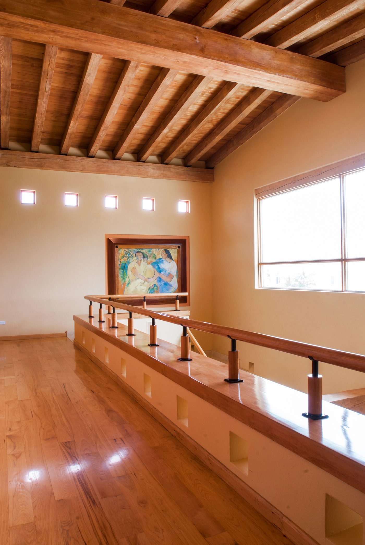 Interior gallery with exposed timber ceiling, wood floor and clerestory windows