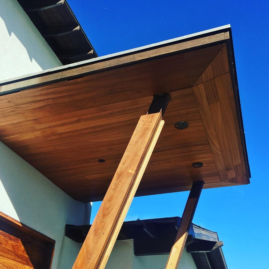 The timber canopy and its brackets seen from below against the sky