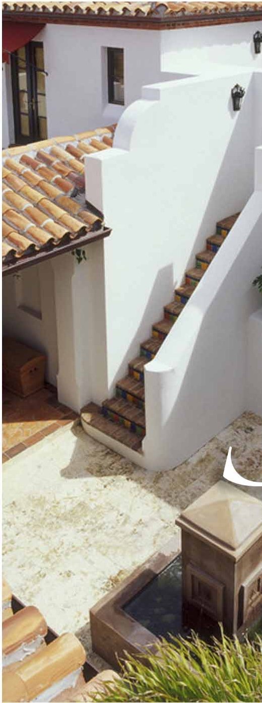 Whitewashed house with tiled roofs and an outside stair