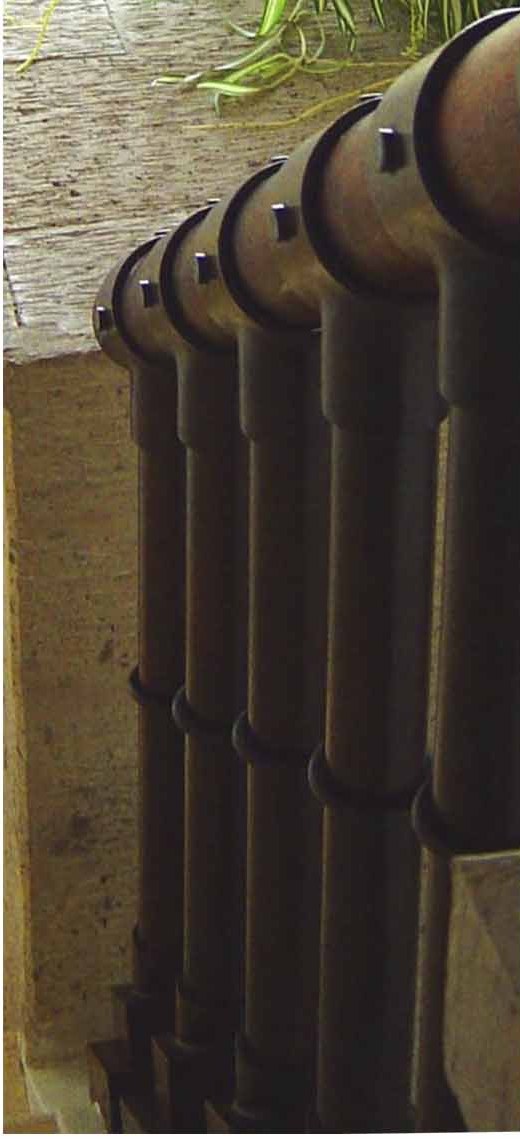 Row of clay roof tiles set as water spouts along a wall